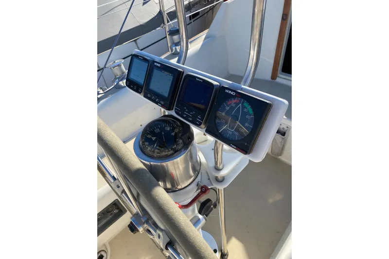 Slide: The Image of 1982 O'Day 34 sailboat cockpit with steering wheel and navigation instruments. - 8