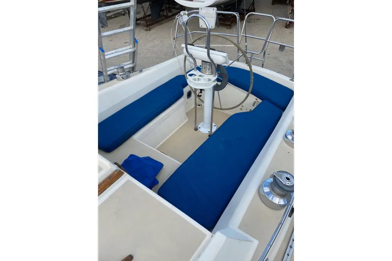 Slide: The Image of Cockpit view of 1982 O'Day 34 sailboat with steering wheel and navigation equipment. - 9