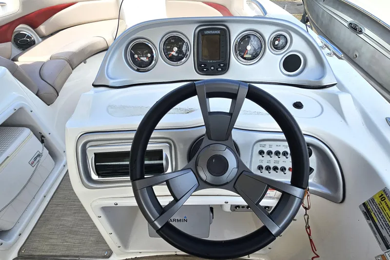 Slide: The Image of 2014 Hurricane SunDeck Sport 203 OB dashboard with steering wheel and gauges. - 10