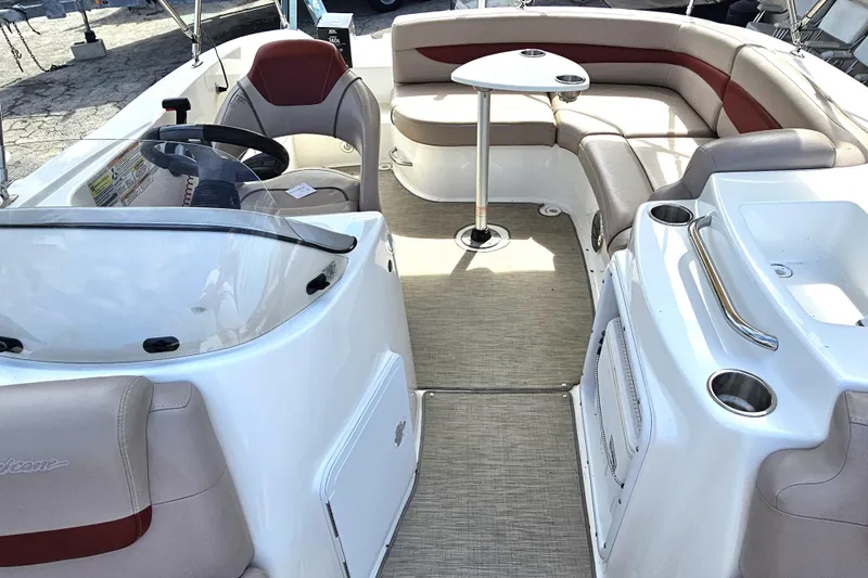 Slide: The Image of 2014 Hurricane SunDeck Sport 203 OB boat interior with seating and steering console. - 18