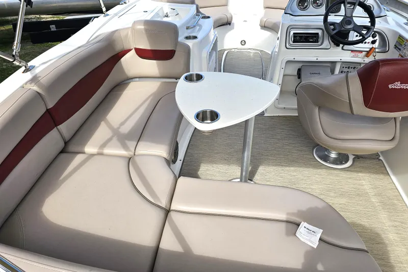 Slide: The Image of 2014 Hurricane SunDeck Sport 203 OB boat interior with seating, table, and steering console. - 20