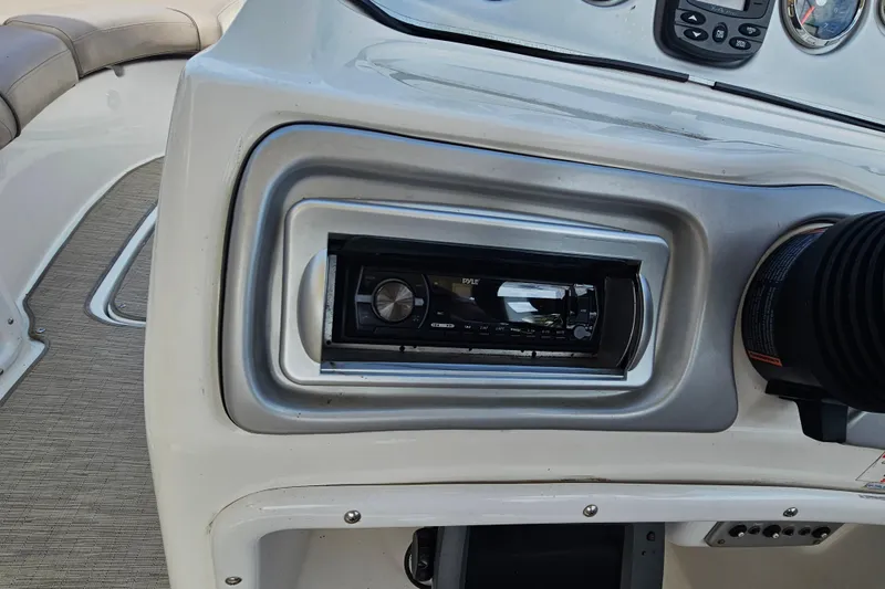 Slide: The Image of 2014 Hurricane SunDeck Sport 203 OB dashboard with stereo system and controls. - 23