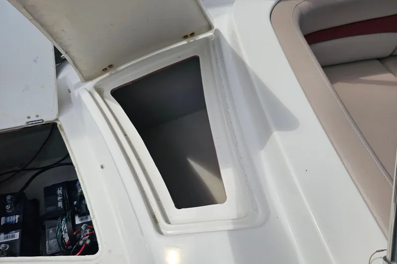 Slide: The Image of Open storage compartment on a 2014 Hurricane SunDeck Sport 203 OB boat. - 24