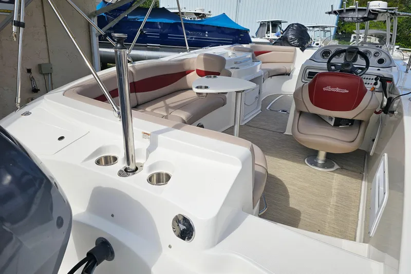 Slide: The Image of 2014 Hurricane SunDeck Sport 203 OB boat interior with seating and steering console. - 7
