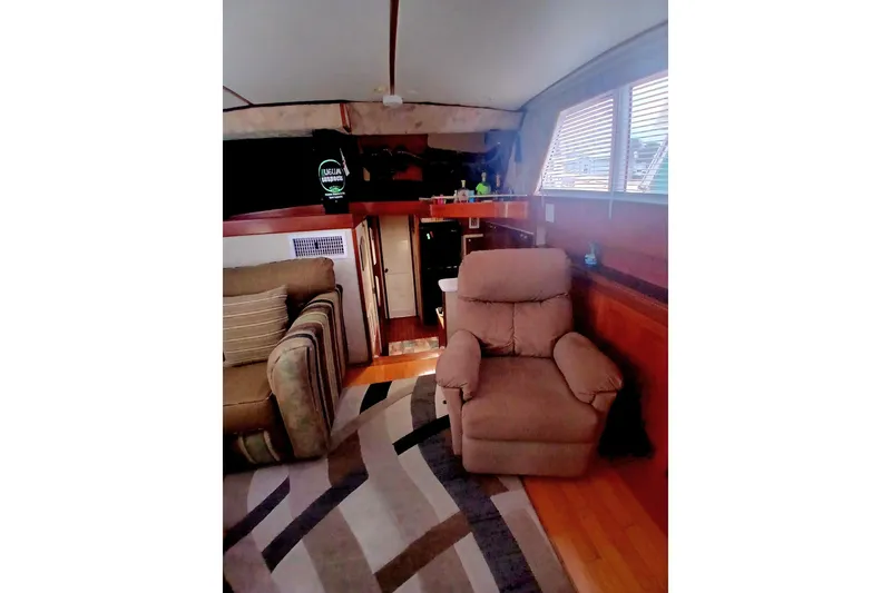 Slide: The Image of Interior of 1976 Viking 40 Sedan Diesel boat with cozy seating and wooden accents. - 13