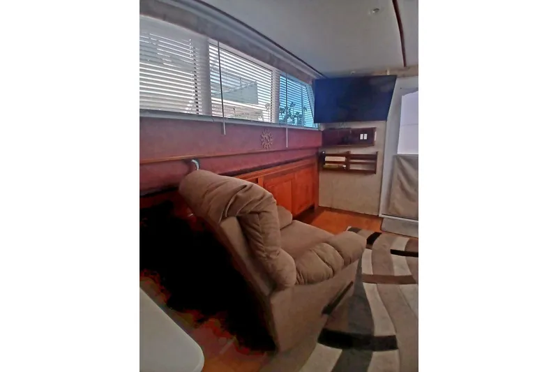 Slide: The Image of Interior of 1976 Viking 40 Sedan Diesel with recliner, TV, and window blinds. - 14