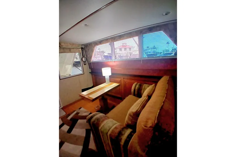 Slide: The Image of Interior of a 1976 Viking 40 Sedan Diesel with cozy seating and a table lamp. - 15