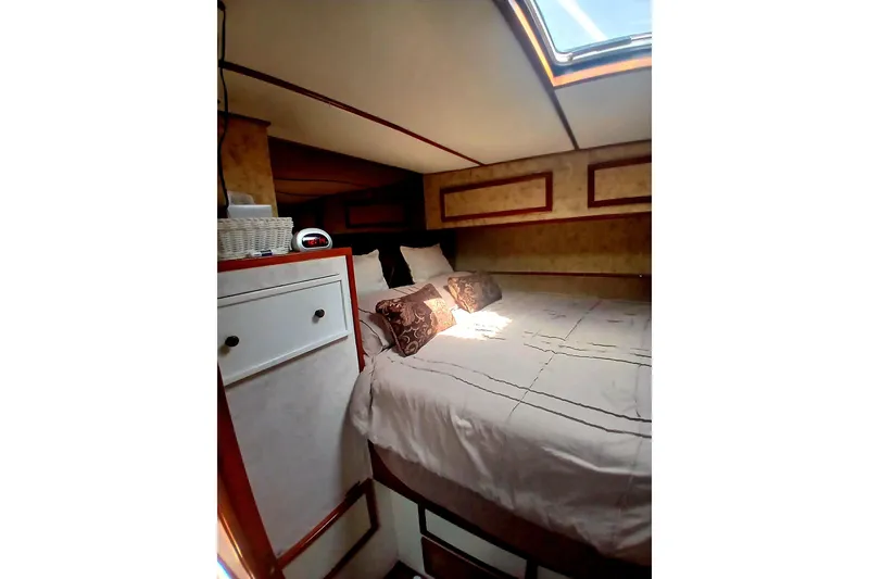 Slide: The Image of Cozy bedroom interior of 1976 Viking 40 Sedan Diesel boat with skylight and elegant decor. - 21