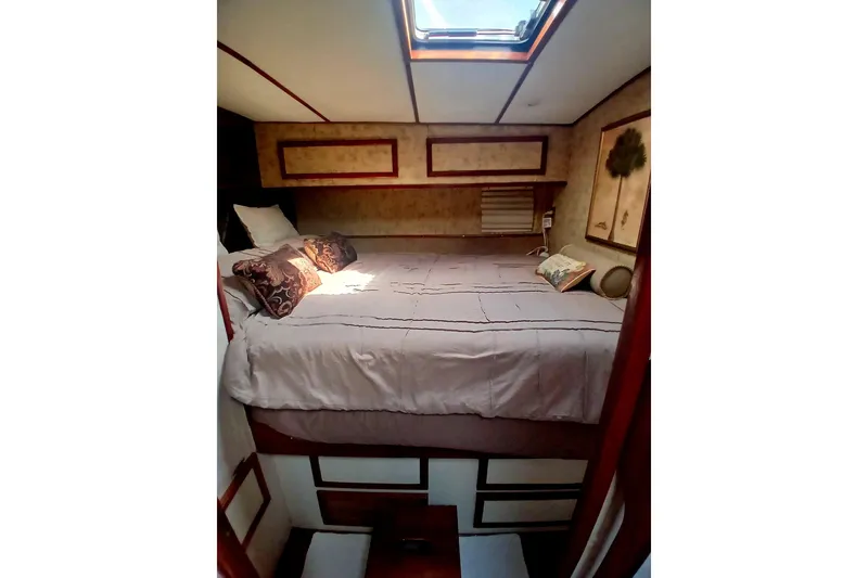 Slide: The Image of Cozy bedroom interior of 1976 Viking 40 Sedan Diesel boat with skylight and decorative pillows. - 23