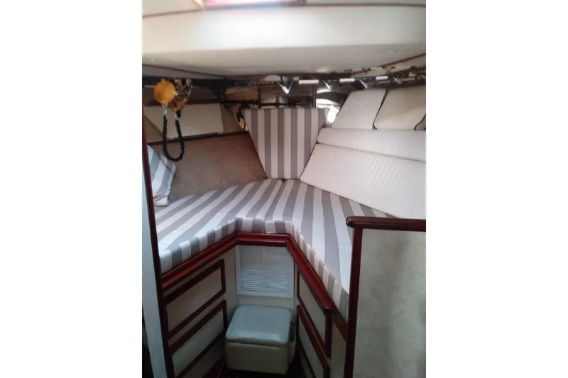 Slide: The Image of Interior cabin of 1976 Viking 40 Sedan Diesel with striped bedding and wooden accents. - 25