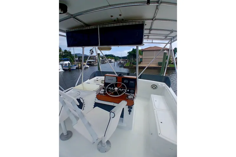Slide: The Image of 1976 Viking 40 Sedan Diesel boat interior with steering wheel and navigation equipment. - 26