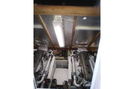 Slide: The Image of Engine room of a 1976 Viking 40 Sedan Diesel boat, featuring dual engines. - 28