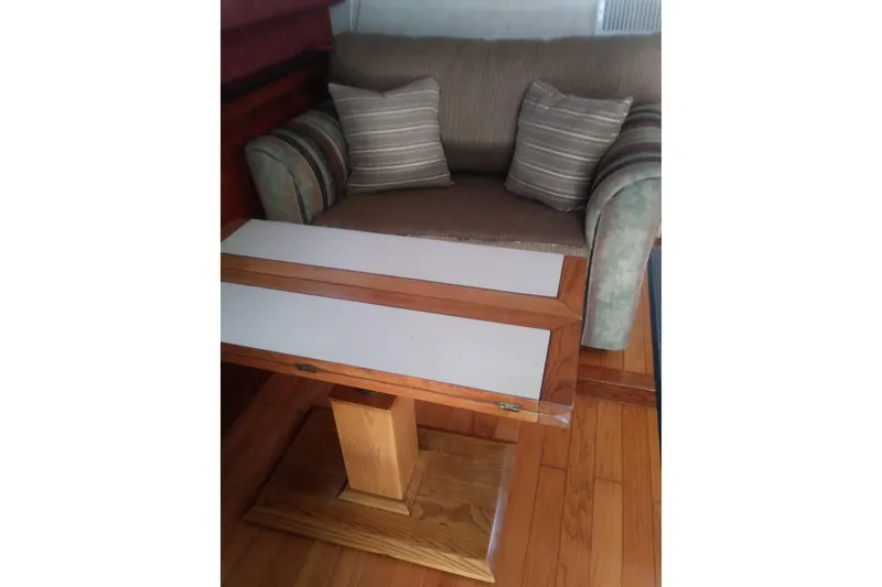 Slide: The Image of Interior of 1976 Viking 40 Sedan Diesel with wooden table and cushioned seating. - 7