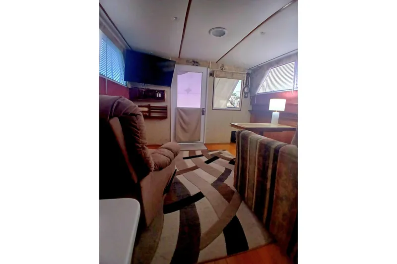 Slide: The Image of Interior of a 1976 Viking 40 Sedan Diesel boat with cozy seating and modern decor. - 8