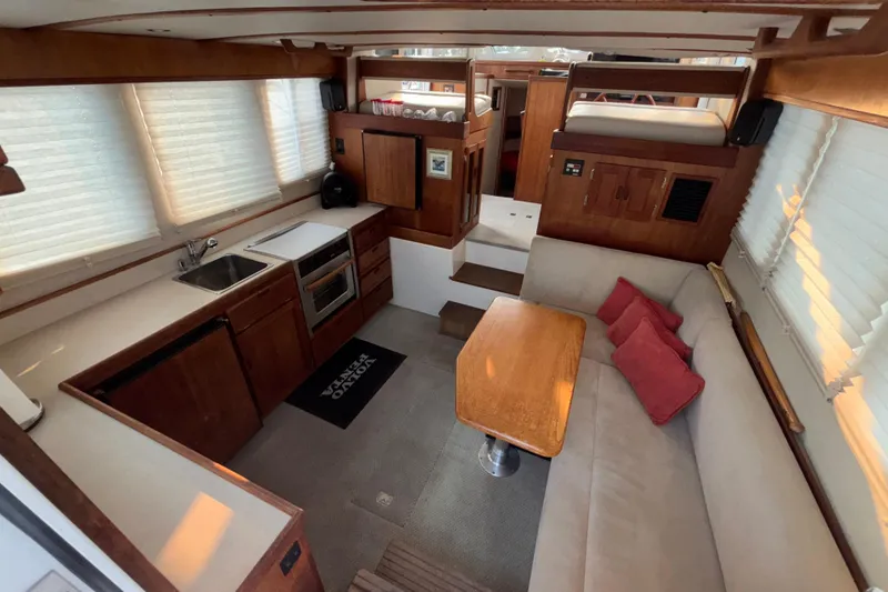Slide: The Image of Interior of 2007 Nordic Tug 32 with cozy seating, kitchen, and dining area. - 10