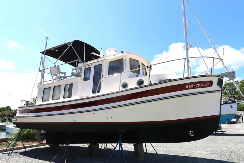 Slide: The Image of 2007 Nordic Tug 32 boat on dry dock, featuring classic design and spacious deck. - 15
