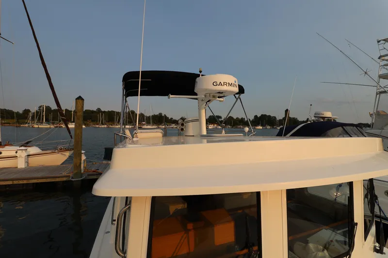 Slide: The Image of 2007 Nordic Tug 32 docked, featuring Garmin radar, with scenic marina backdrop. - 26