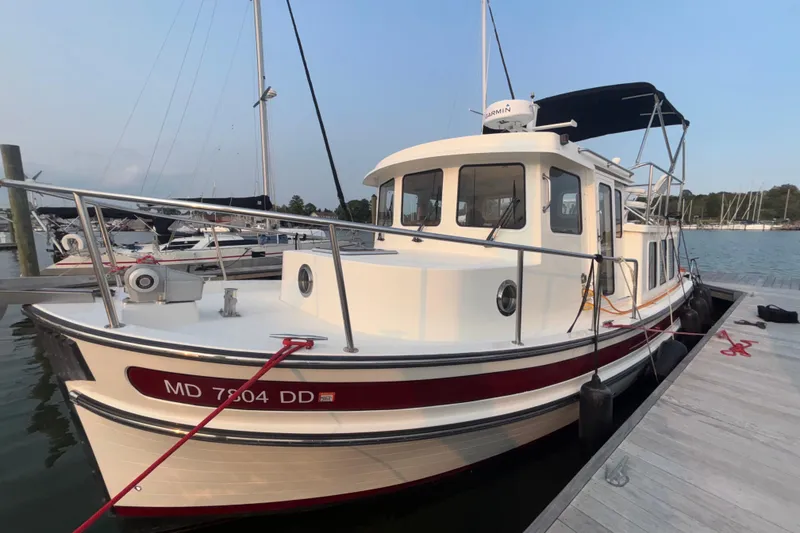 Slide: The Image of 2007 Nordic Tug 32 docked at marina, featuring classic design and sturdy build. - 29