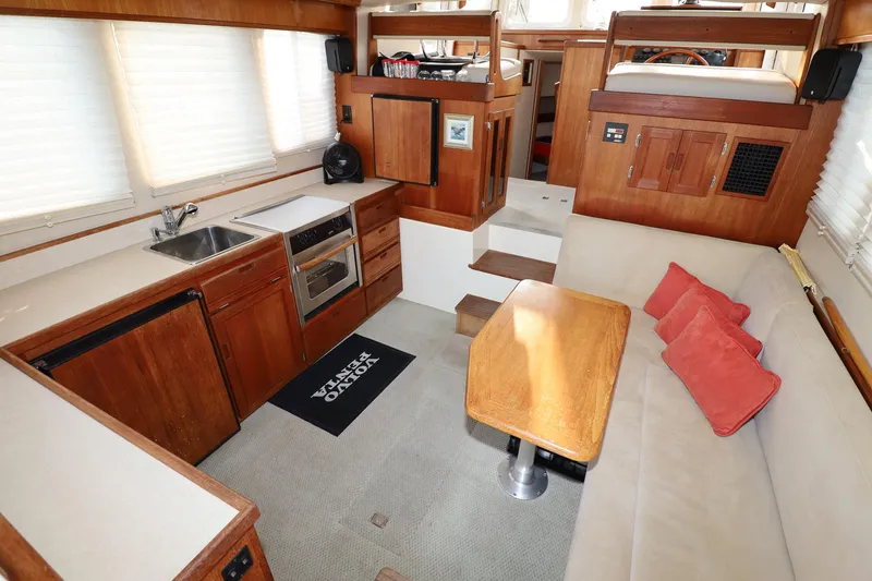 Slide: The Image of Interior of 2007 Nordic Tug 32 with kitchen, seating area, and wooden finishes. - 3
