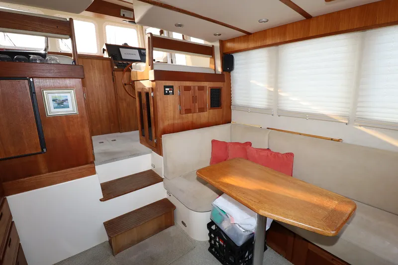 Slide: The Image of Cozy interior of 2007 Nordic Tug 32 with wooden accents and seating area. - 5
