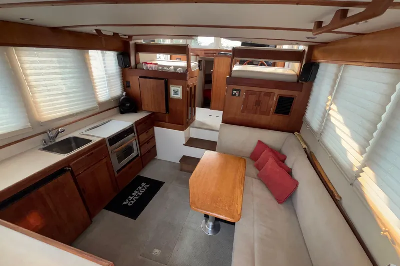 Slide: The Image of Interior of 2007 Nordic Tug 32 with kitchen, seating area, and wooden accents. - 6