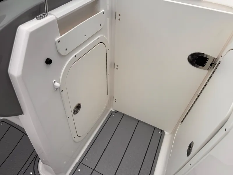 Slide: The Image of 2025 Chaparral 23 SSi OB boat interior with storage compartment and sleek design. - 28