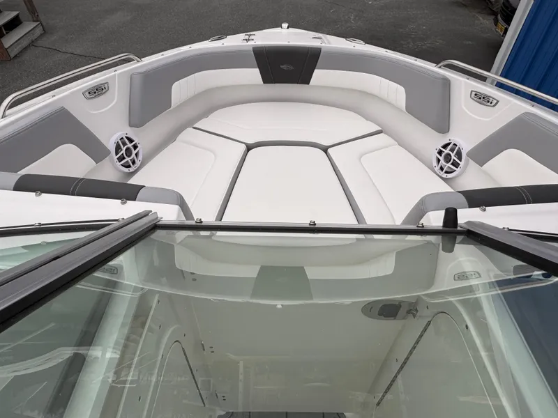 Slide: The Image of 2025 Chaparral 23 SSi OB boat interior with cushioned seating and speakers. - 5