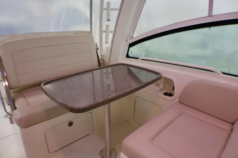 Slide: The Image of Interior seating area of 2020 Boston Whaler 345 Conquest with table and cushioned seats. - 11