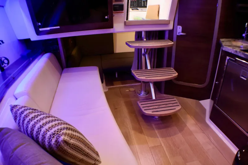 Slide: The Image of Interior of 2020 Boston Whaler 345 Conquest with modern seating and wooden steps. - 13