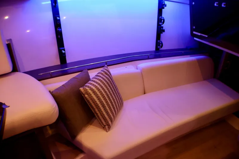 Slide: The Image of Interior of 2020 Boston Whaler 345 Conquest with cozy seating and ambient lighting. - 16