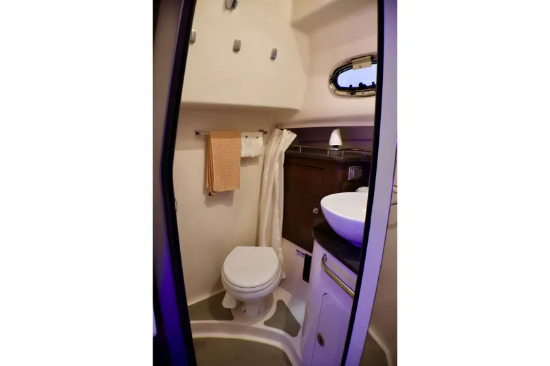 Slide: The Image of 2020 Boston Whaler 345 Conquest bathroom with toilet, sink, and towel rack. - 17