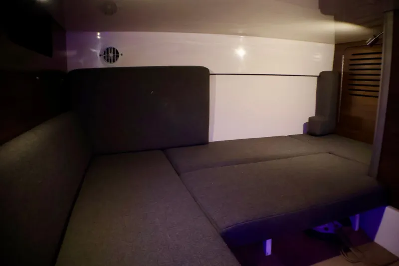 Slide: The Image of 2020 Boston Whaler 345 Conquest cabin interior with cushioned seating. - 19