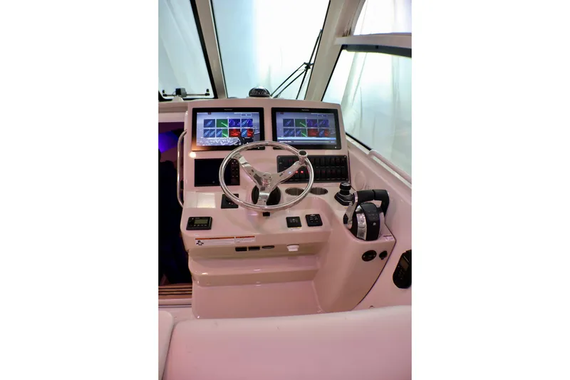 Slide: The Image of Helm of 2020 Boston Whaler 345 Conquest with dual navigation screens and controls. - 8