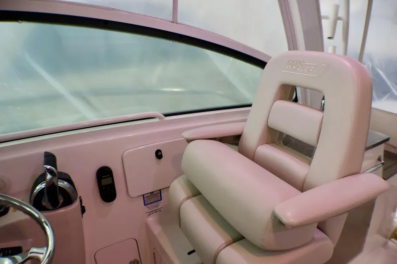 Slide: The Image of Captain's seat on 2020 Boston Whaler 345 Conquest boat, featuring luxurious design and controls. - 9