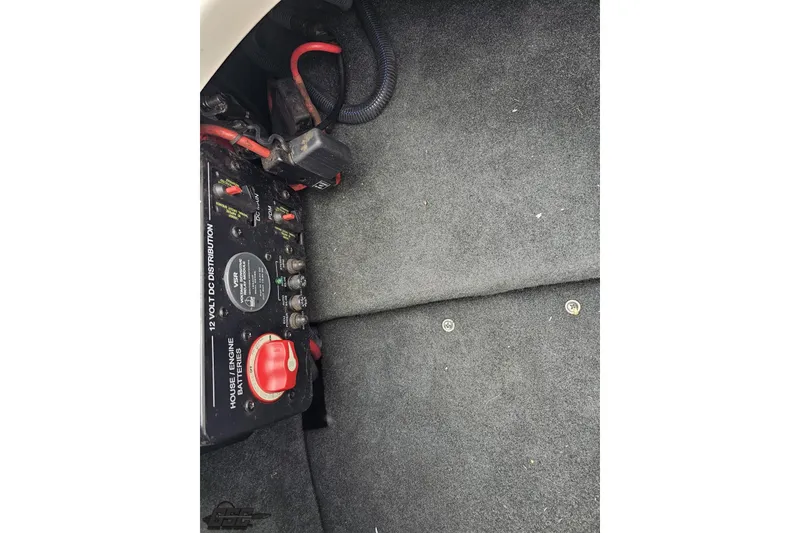 Slide: The Image of 2013 MasterCraft X-10 boat battery compartment with 12-volt DC distribution panel. - 100