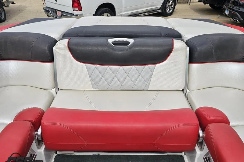 Slide: The Image of 2013 MasterCraft X-10 boat interior with red, white, and black seating. - 101