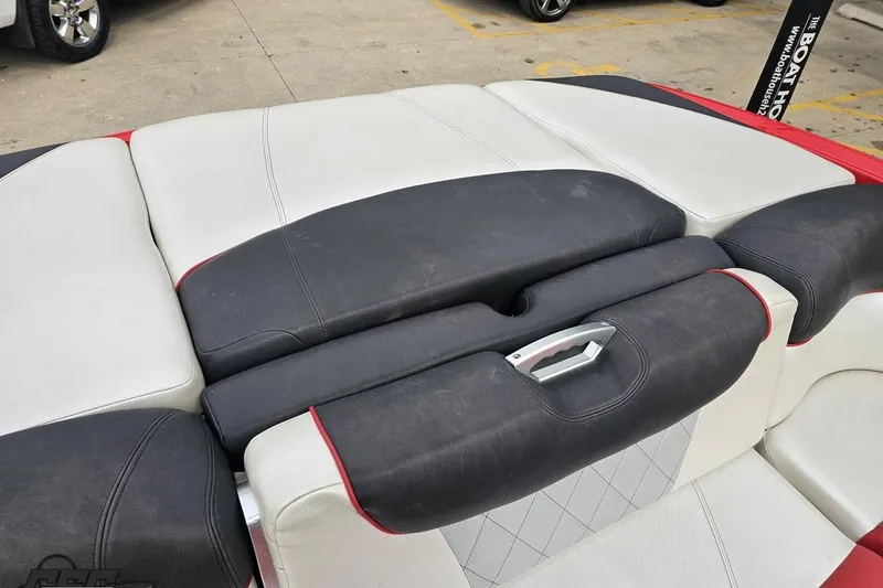 Slide: The Image of 2013 MasterCraft X-10 boat interior with black and white cushioned seating. - 102