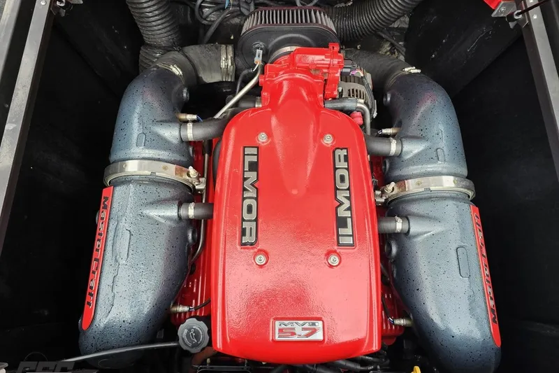 Slide: The Image of 2013 MasterCraft X-10 Ilmor MV8 5.7 engine, red and black components, top view. - 104