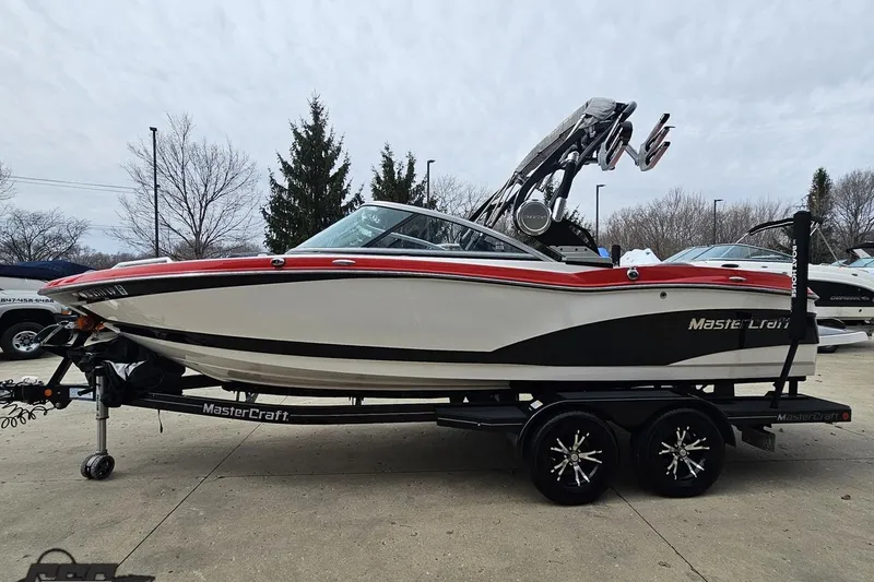 Slide: The Image of 2013 MasterCraft X-10 boat on trailer, featuring sleek design and vibrant red accents. - 24