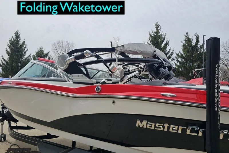 Slide: The Image of 2013 MasterCraft X-10 boat with folding waketower, red and white design. - 32
