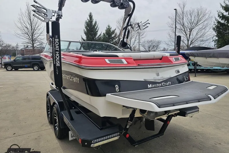 Slide: The Image of 2013 MasterCraft X-10 boat on trailer, rear view, parked outdoors. - 34