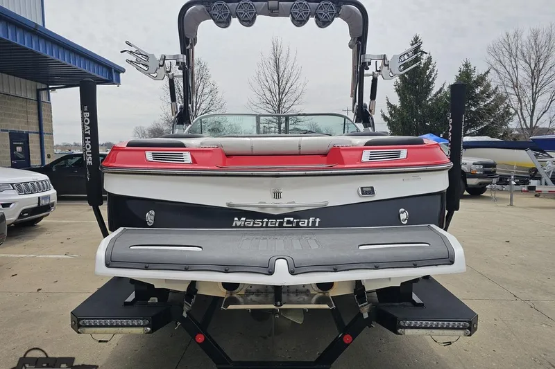 Slide: The Image of 2013 MasterCraft X-10 boat, rear view, parked outdoors with wakeboard tower. - 35