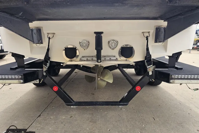 Slide: The Image of Rear view of a 2013 MasterCraft X-10 boat on a trailer, showing propeller and exhaust. - 37