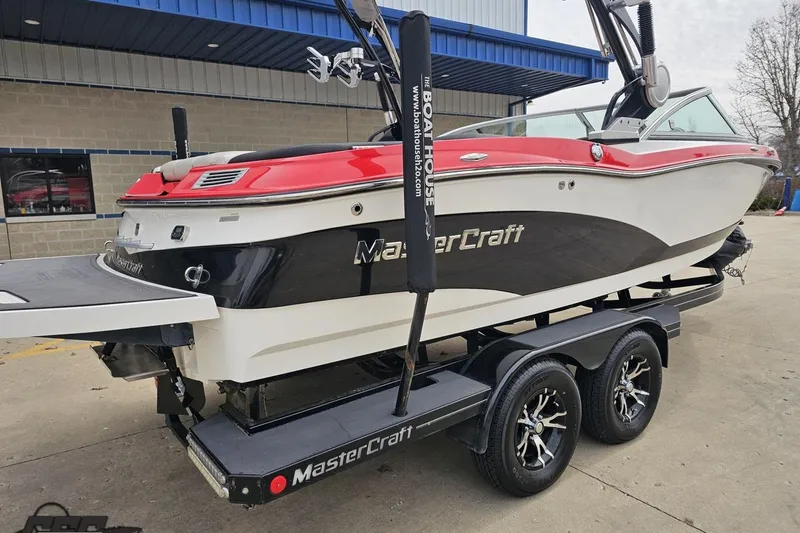 Slide: The Image of 2013 MasterCraft X-10 boat on trailer, featuring sleek design and vibrant red accents. - 39