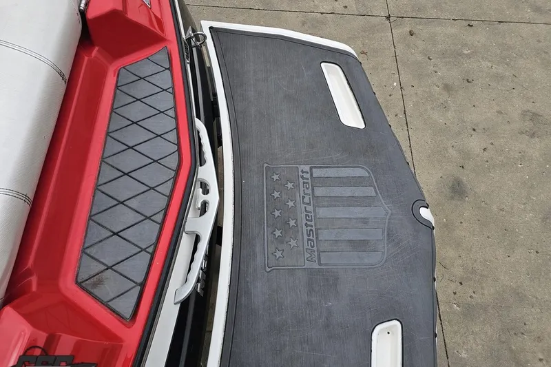 Slide: The Image of 2013 MasterCraft X-10 boat with red and gray detailing on the deck. - 41