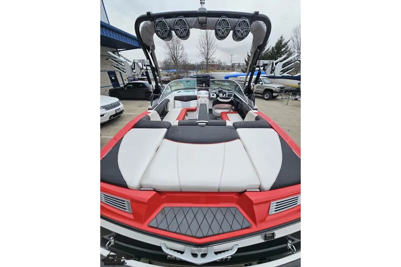 Slide: The Image of 2013 MasterCraft X-10 boat with red and white interior, featuring tower speakers and spacious seating. - 42