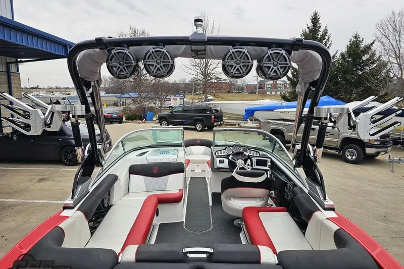 Slide: The Image of 2013 MasterCraft X-10 boat interior with red and white seating, speakers, and dashboard. - 45