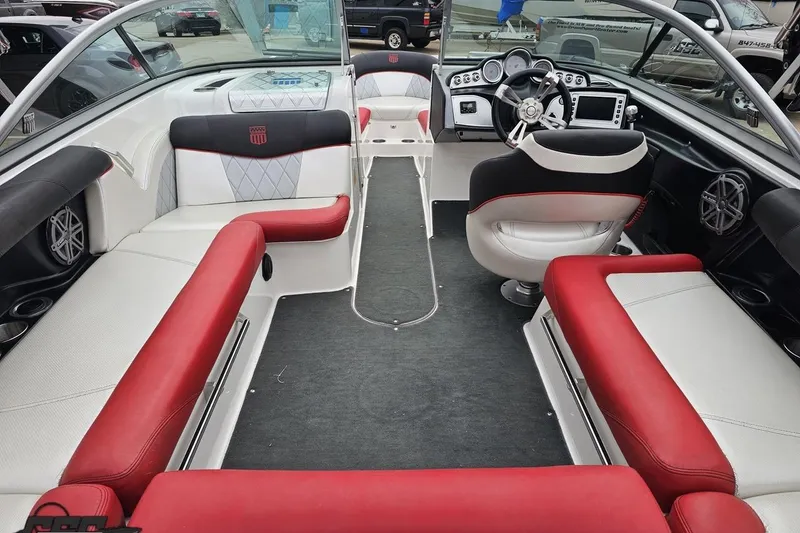 Slide: The Image of Interior of a 2013 MasterCraft X-10 boat with red and white seating. - 48