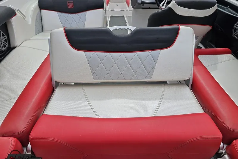 Slide: The Image of 2013 MasterCraft X-10 boat interior with red and white seating, diamond pattern upholstery. - 50