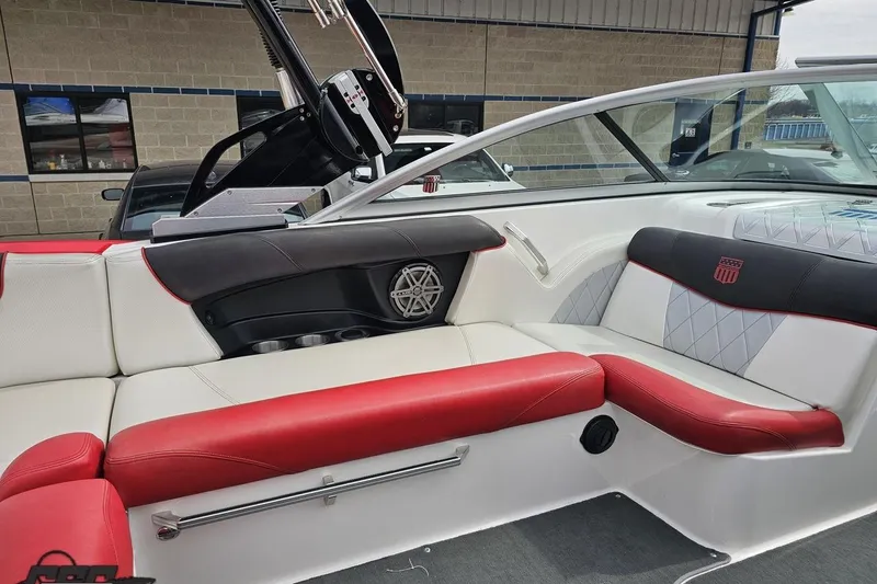 Slide: The Image of 2013 MasterCraft X-10 boat interior with red and white seating, featuring modern design elements. - 55